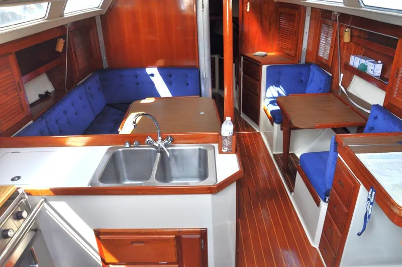 Slide: The Image of Interior of 1987 Catalina 36 Tall Rig sailboat with wood finish and blue upholstery. - 19