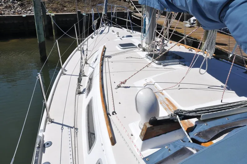 Slide: The Image of 1987 Catalina 36 Tall Rig sailboat deck with rigging and wooden accents. - 7