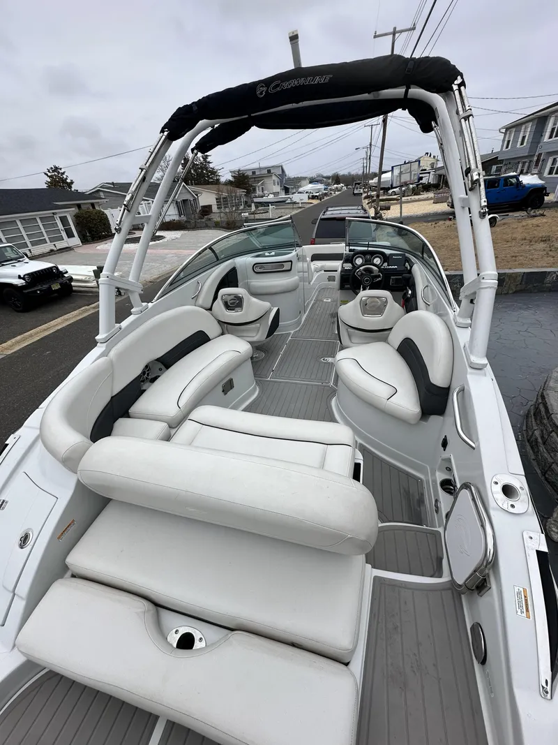 Slide: The Image of 2018 Crownline Eclipse E24 XS boat with white seating and sleek design. - 3