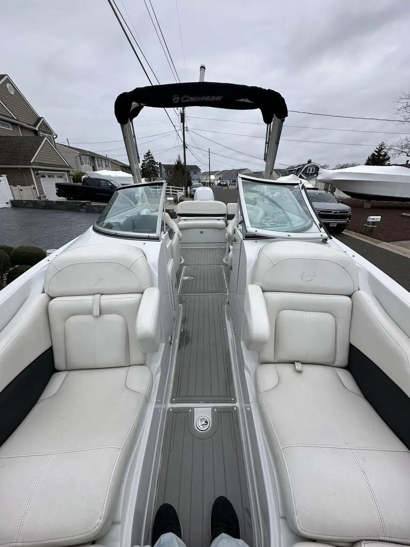 Slide: The Image of 2018 Crownline Eclipse E24 XS boat interior with white seating and sleek design. - 4