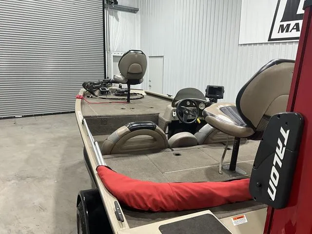 Slide: The Image of 2011 G3 170 boat in garage, featuring seats and steering console. - 13