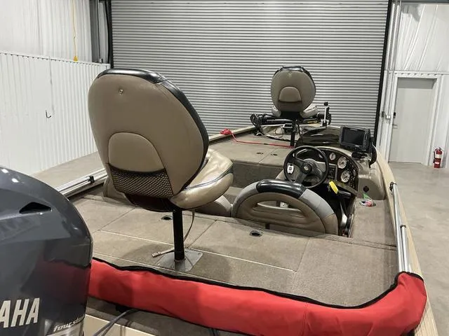 Slide: The Image of 2011 G3 170 boat interior with Yamaha motor, dual seats, and control panel in a garage. - 15