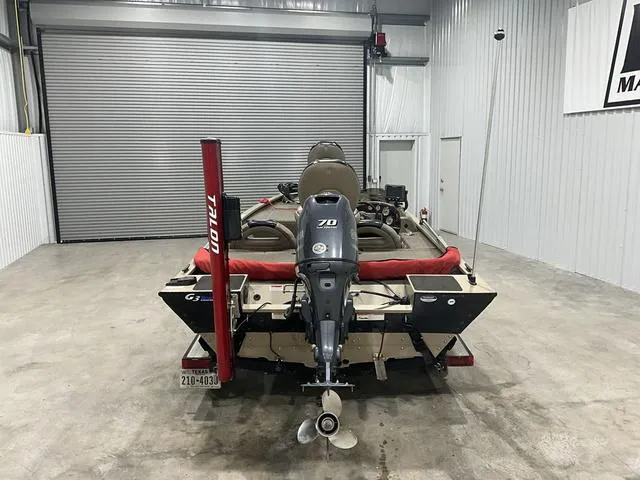 Slide: The Image of Rear view of a 2011 G3 170 boat with an outboard motor in a garage. - 3