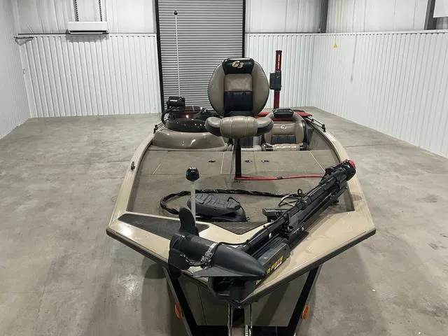 Slide: The Image of 2011 G3 170 boat in storage, featuring a trolling motor and fishing seat. - 8