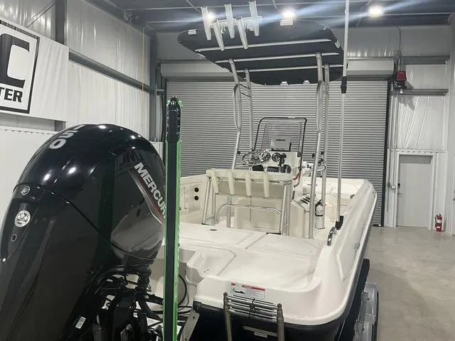 Slide: The Image of 2021 Bayliner T21BAY boat with Mercury outboard motor in a storage facility. - 16