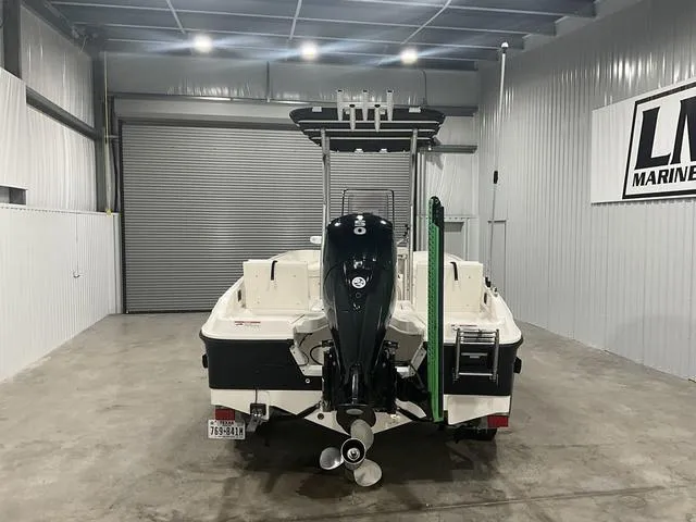 Slide: The Image of 2021 Bayliner T21BAY boat in a garage, rear view with outboard motor. - 5