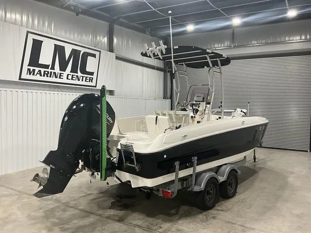 Slide: The Image of 2021 Bayliner T21BAY boat in LMC Marine Center showroom, featuring a sleek black and white design. - 7