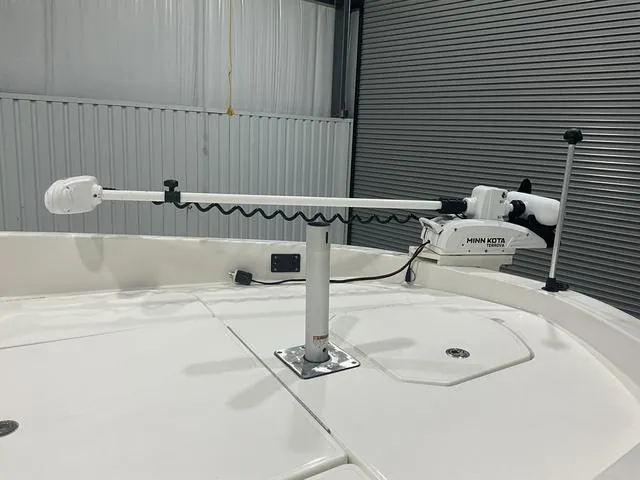 Slide: The Image of 2021 Bayliner T21BAY boat with Minn Kota trolling motor in a garage. - 9