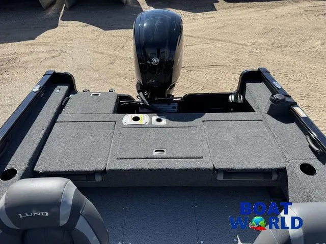 Slide: The Image of 2023 Lund 1675 Adventure Sport boat interior with motor, featuring spacious seating and storage. - 10
