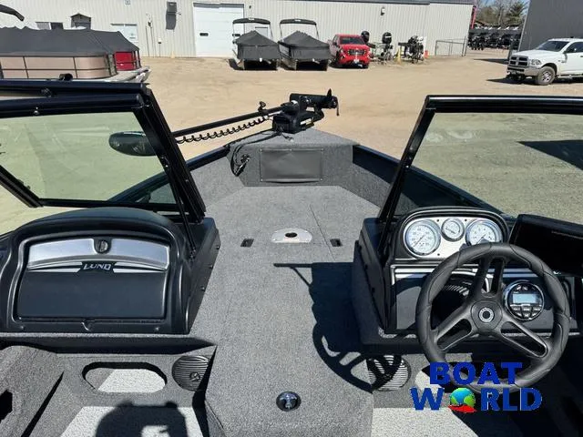 Slide: The Image of 2023 Lund 1675 Adventure Sport boat interior with steering wheel and dashboard, displayed at Boat World. - 13