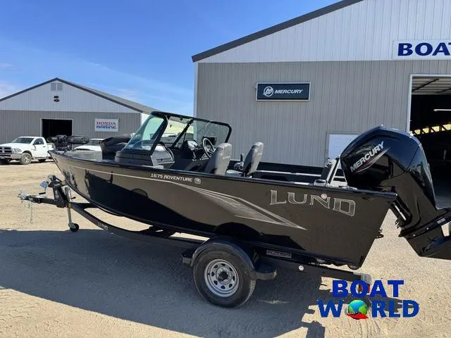Slide: The Image of 2023 Lund 1675 Adventure Sport boat on trailer at dealership, featuring Mercury engine. - 20