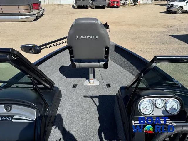 Slide: The Image of 2023 Lund 1675 Adventure Sport boat interior with steering console and seating. - 3