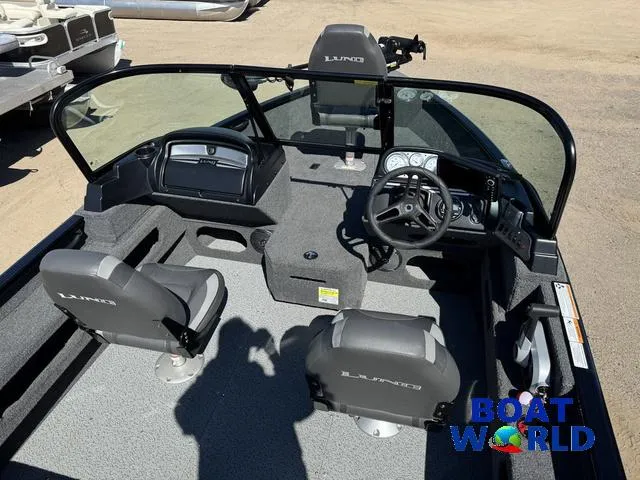 Slide: The Image of 2023 Lund 1675 Adventure Sport boat interior with steering wheel and seating. - 7