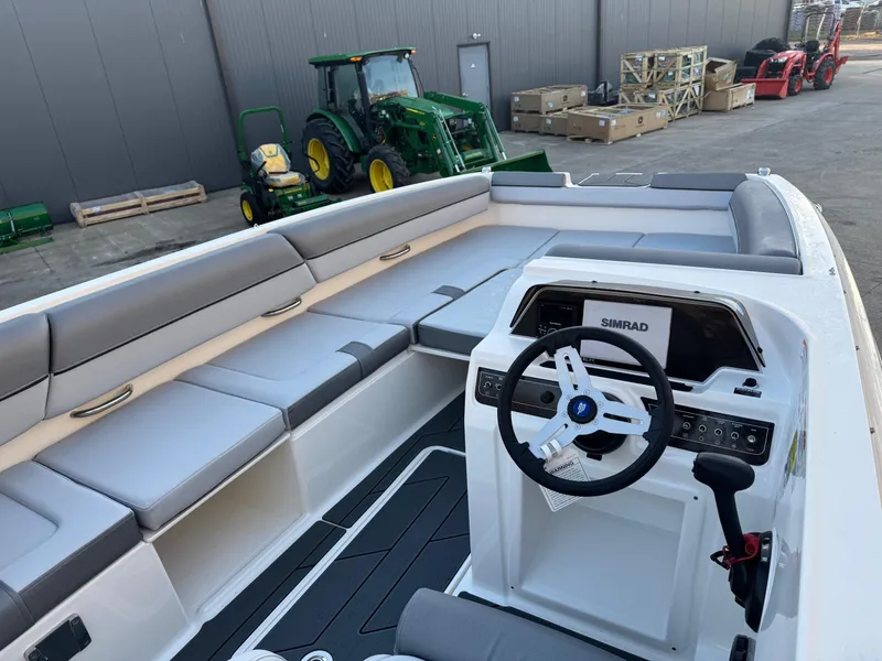 Slide: The Image of 2025 Bayliner D20 boat interior with modern steering, spacious seating, and sleek design. - 12