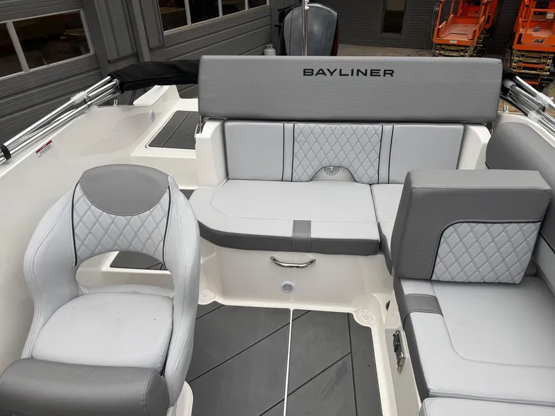 Slide: The Image of 2025 Bayliner D20 boat interior with gray seating and modern design. - 14