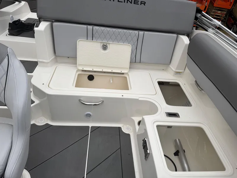 Slide: The Image of 2025 Bayliner D20 boat interior with storage compartments and seating. - 15