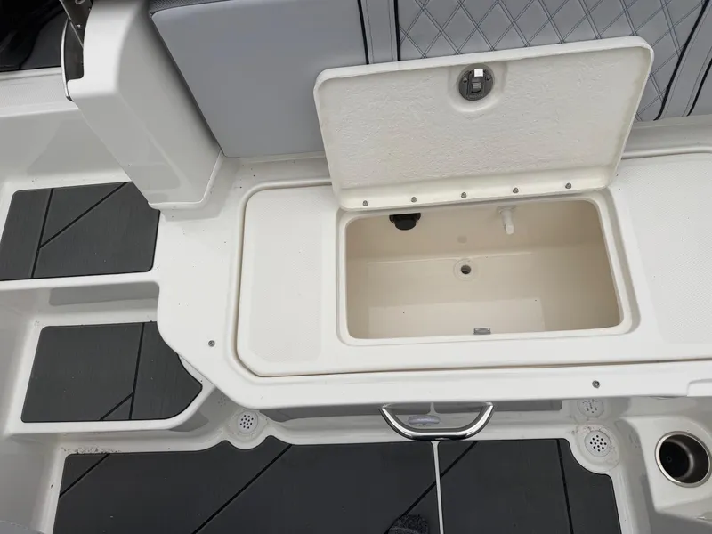 Slide: The Image of 2025 Bayliner D20 boat storage compartment with open lid, showcasing interior space. - 16