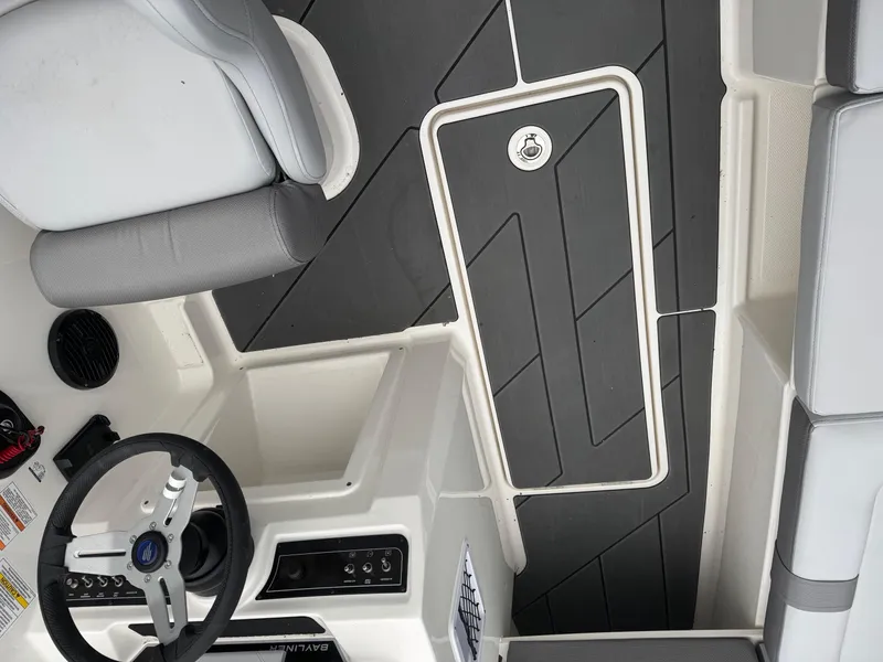 Slide: The Image of Interior view of 2025 Bayliner D20 boat, featuring sleek seating and modern dashboard. - 19