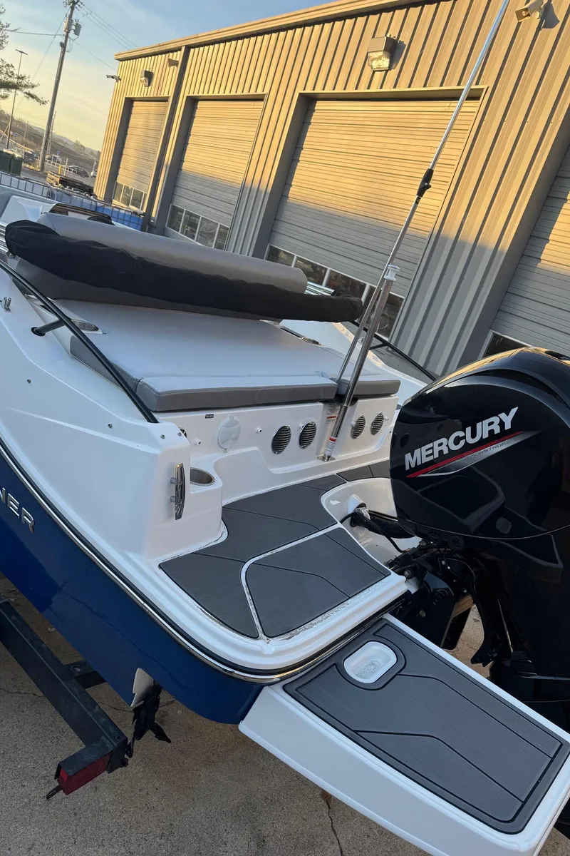 Slide: The Image of 2025 Bayliner D20 boat with Mercury engine, docked near industrial building. - 22