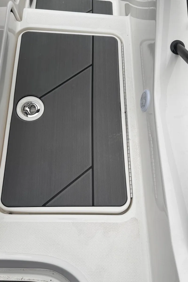 Slide: The Image of 2025 Bayliner D20 boat deck with sleek, modern design and secure hatch. - 23