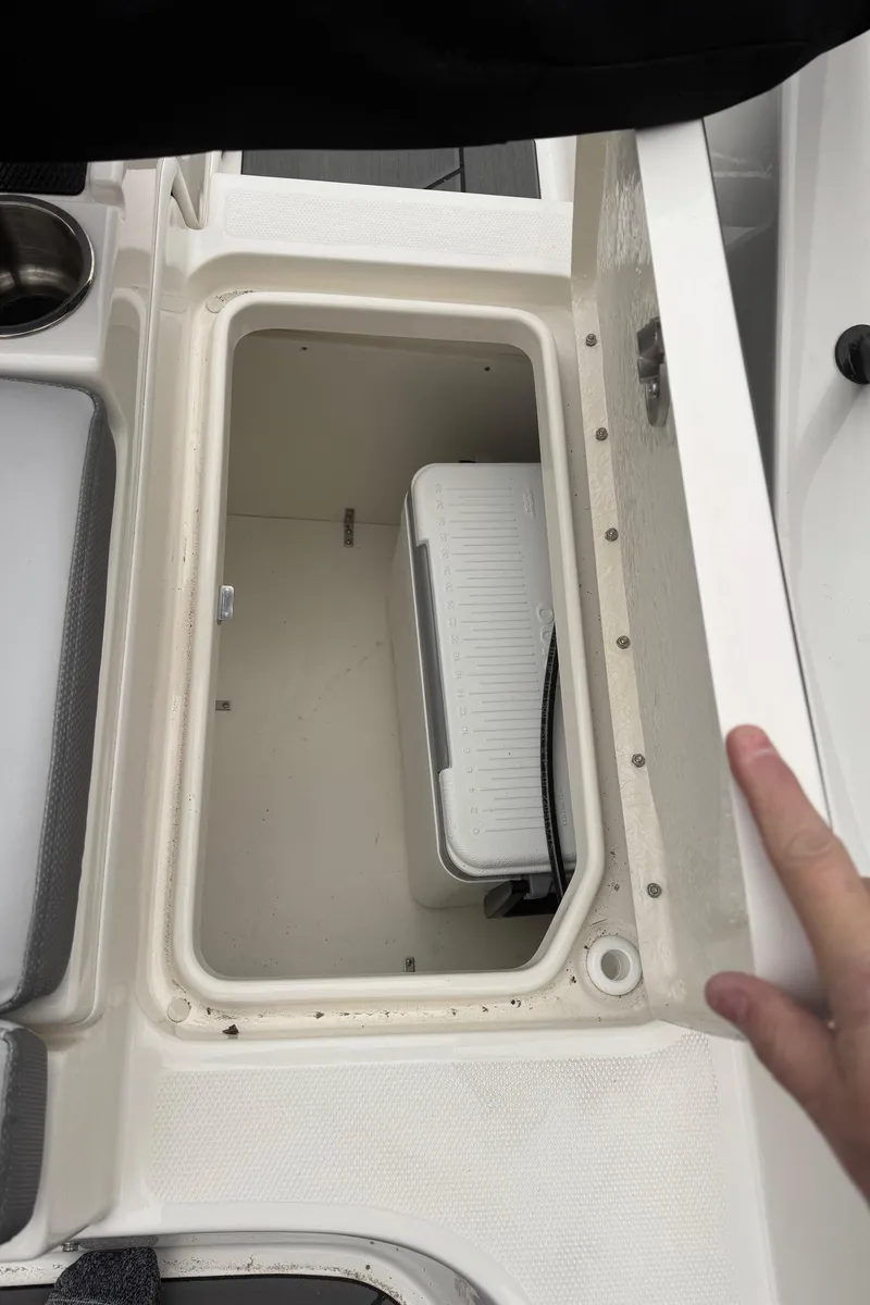 Slide: The Image of 2025 Bayliner D20 boat storage compartment with cooler inside. - 24