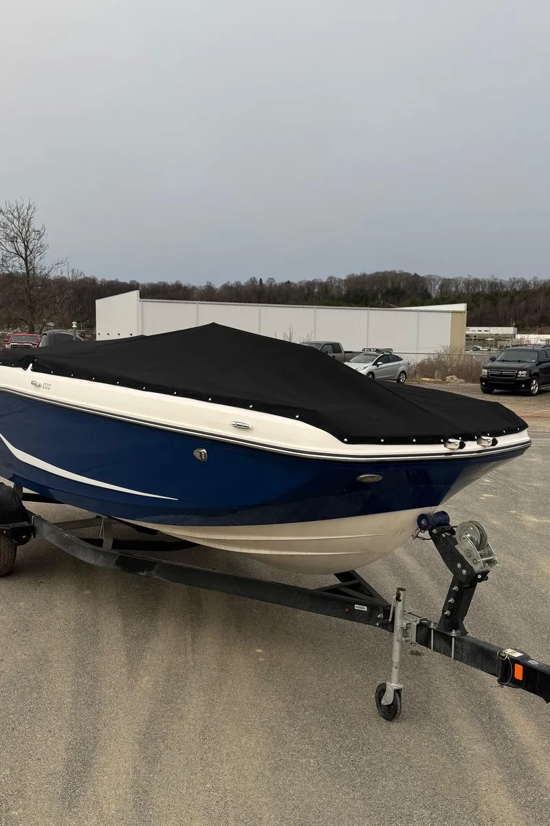 Slide: The Image of 2025 Bayliner D20 boat with cover on trailer, parked outdoors. - 25