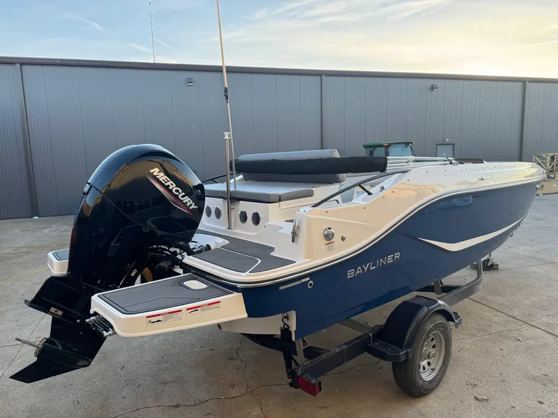 Slide: The Image of 2025 Bayliner D20 boat with Mercury engine on a trailer, parked outdoors. - 3