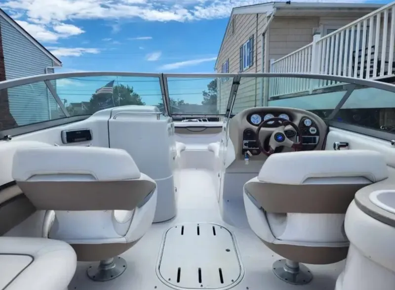 Slide: The Image of 2005 Four Winns 230 Horizon boat interior with white seating and dashboard. - 5