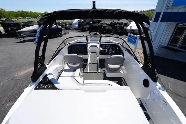 Slide: The Image of 2025 Bayliner V20i boat interior with seating and steering wheel, displayed outdoors. - 10
