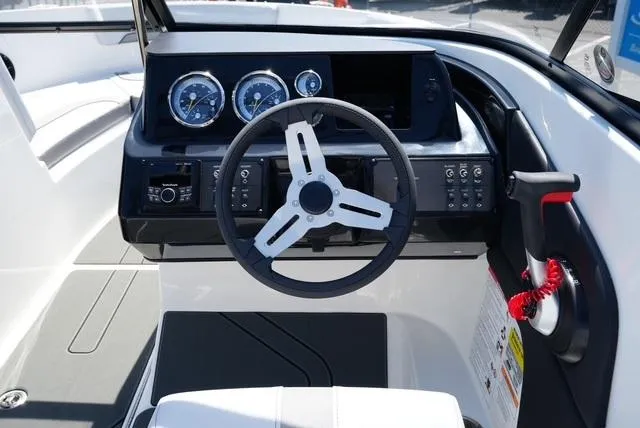 Slide: The Image of 2025 Bayliner V20i boat dashboard with steering wheel and instrument panel. - 16