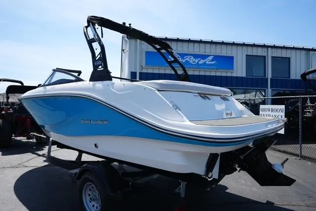 Slide: The Image of 2025 Bayliner V20i boat in showroom, featuring sleek design and blue accents. - 9