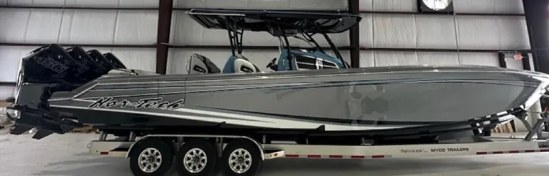 Slide: The Image of 2024 Nor-Tech 390 Sport boat on trailer in indoor storage facility. - 0