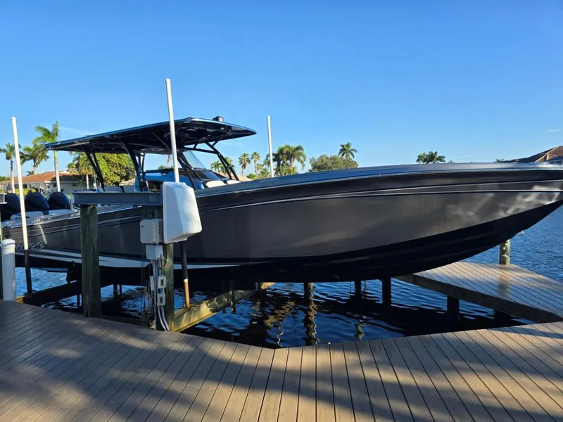 Slide: The Image of 2024 Nor-Tech 390 Sport boat docked on a sunny day, showcasing sleek design and modern features. - 1
