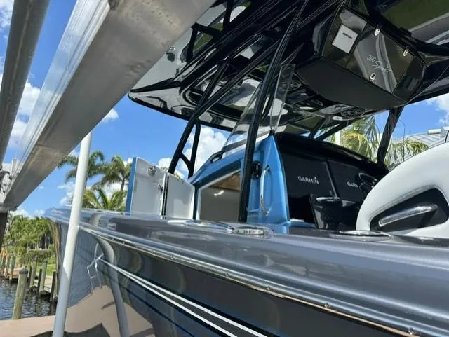 Slide: The Image of 2024 Nor-Tech 390 Sport boat docked, featuring sleek design and advanced Garmin navigation system. - 13