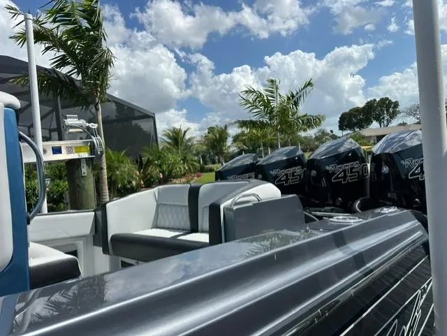 Slide: The Image of 2024 Nor-Tech 390 Sport boat with powerful engines, set against a tropical backdrop. - 14