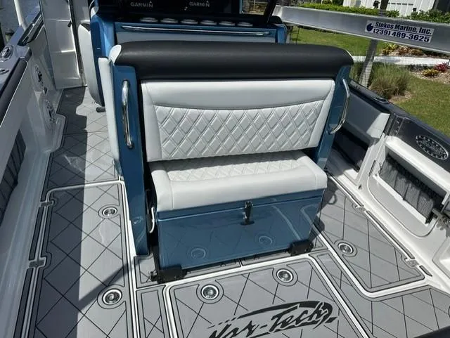 Slide: The Image of 2024 Nor-Tech 390 Sport boat interior with diamond-stitched seating and custom flooring. - 21