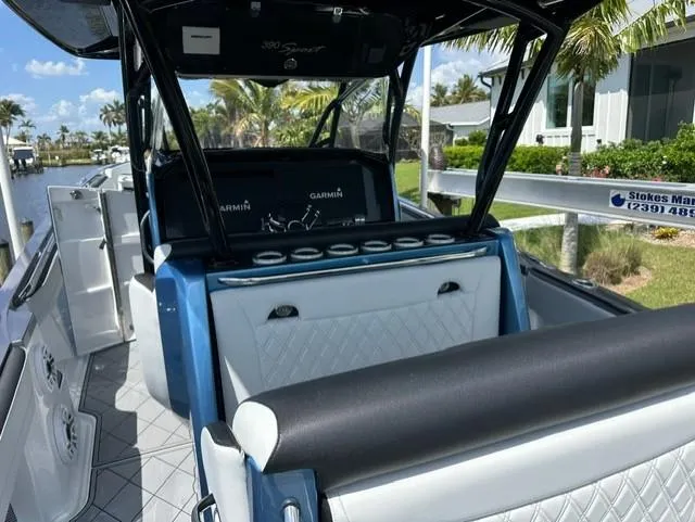Slide: The Image of 2024 Nor-Tech 390 Sport boat interior with luxurious seating and modern navigation equipment. - 23