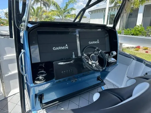 Slide: The Image of 2024 Nor-Tech 390 Sport boat dashboard with Garmin navigation system. - 24