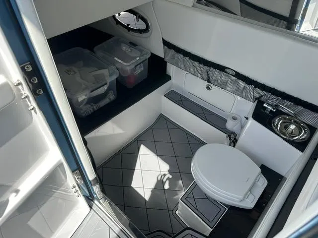 Slide: The Image of 2024 Nor-Tech 390 Sport boat interior with toilet, storage, and sink. - 25