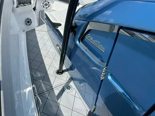 Slide: The Image of 2024 Nor-Tech 390 Sport boat interior with sleek blue finish and modern design elements. - 27
