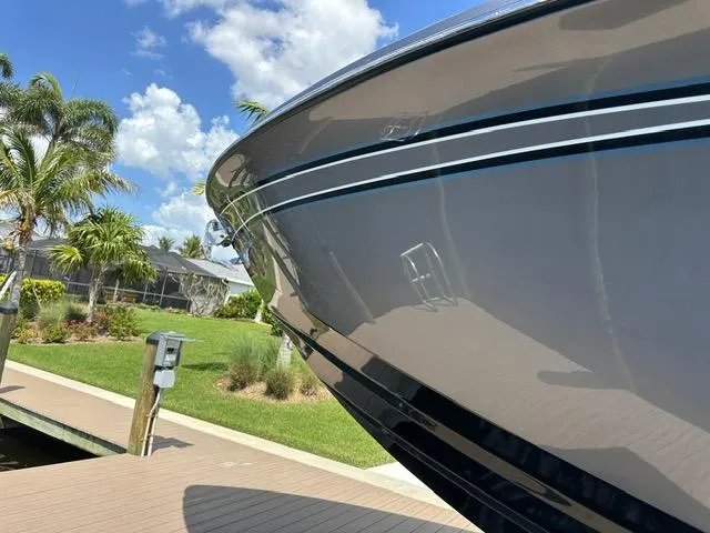 Slide: The Image of 2024 Nor-Tech 390 Sport boat docked, showcasing sleek design under a sunny sky. - 3