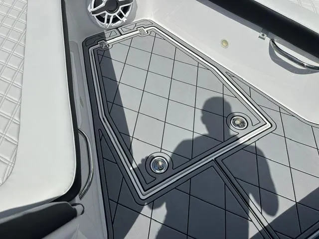 Slide: The Image of 2024 Nor-Tech 390 Sport boat deck with diamond-patterned flooring and speaker detail. - 30
