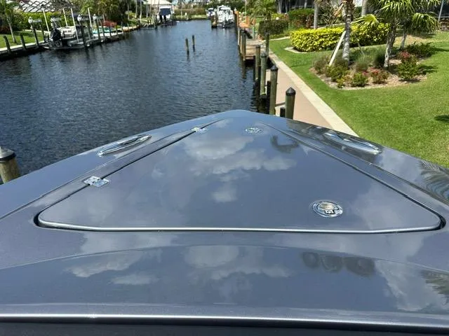 Slide: The Image of 2024 Nor-Tech 390 Sport boat on a calm canal, surrounded by lush greenery. - 31