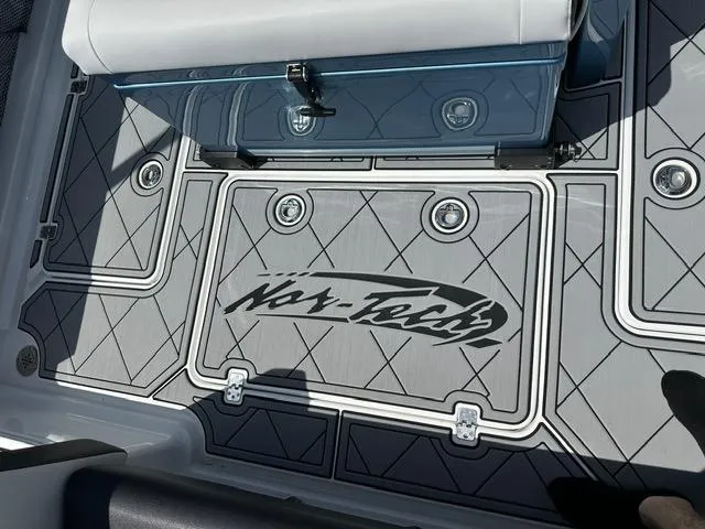 Slide: The Image of 2024 Nor-Tech 390 Sport boat deck with logo and seating area. - 34