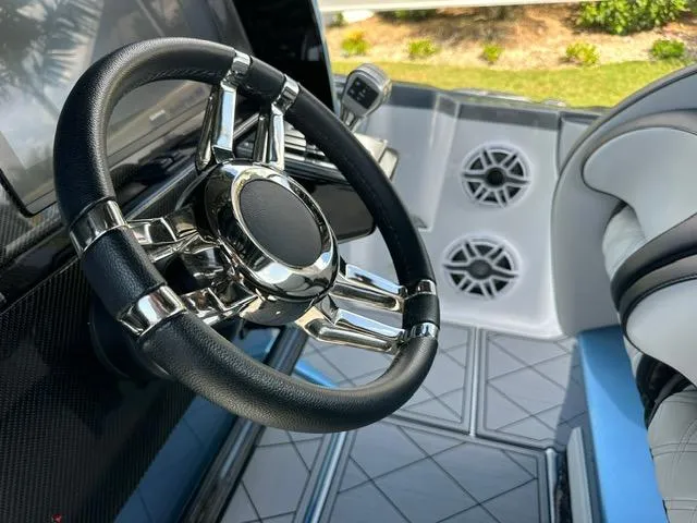 Slide: The Image of 2024 Nor-Tech 390 Sport boat interior with sleek steering wheel and modern design. - 35