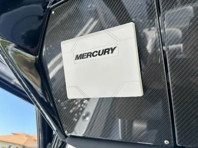 Slide: The Image of Mercury logo on 2024 Nor-Tech 390 Sport boat's carbon fiber panel. - 36