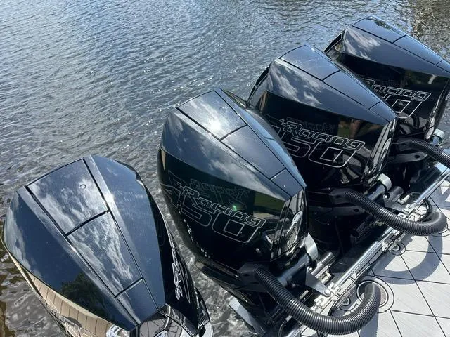 Slide: The Image of Four powerful outboard engines on a 2024 Nor-Tech 390 Sport boat. - 4