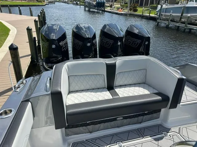 Slide: The Image of 2024 Nor-Tech 390 Sport boat with quad engines and luxurious seating by the dock. - 5