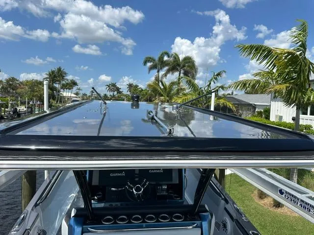 Slide: The Image of 2024 Nor-Tech 390 Sport boat with sleek design under a sunny sky. - 6