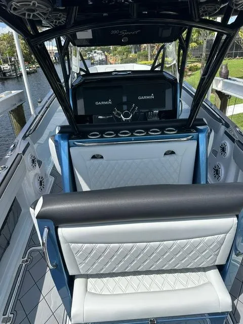 Slide: The Image of 2024 Nor-Tech 390 Sport boat interior with luxury seating and Garmin navigation system. - 8